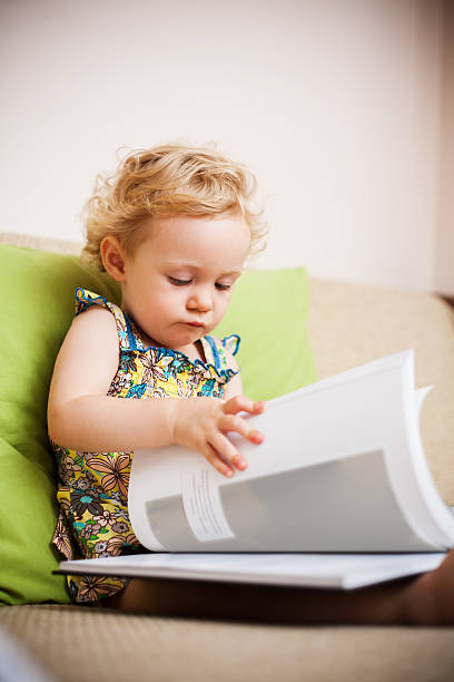 istock Baby girl reading a book 177356903