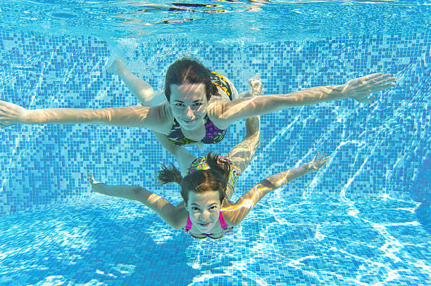 istock Happy smiling family underwater in swimming pool 177358355