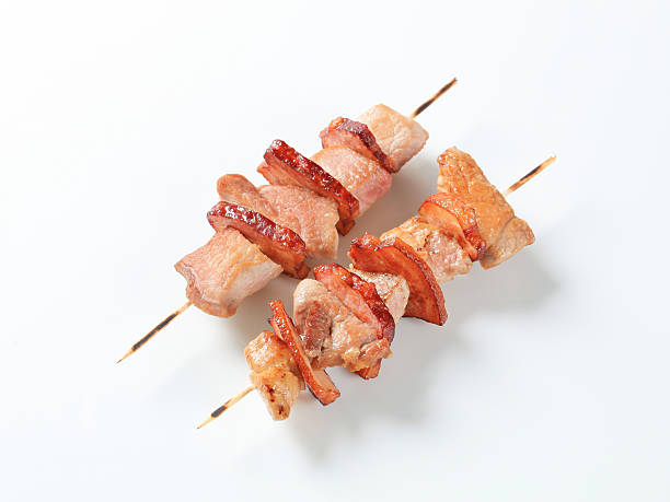 istock Two pork and bacon skewers - studio shot 177359076