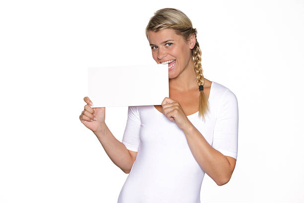 Blonde woman biting into a sign