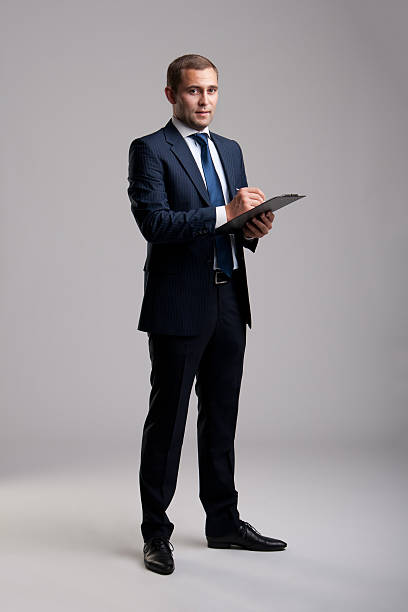 istock Young and successful businessman signing a document 177359932