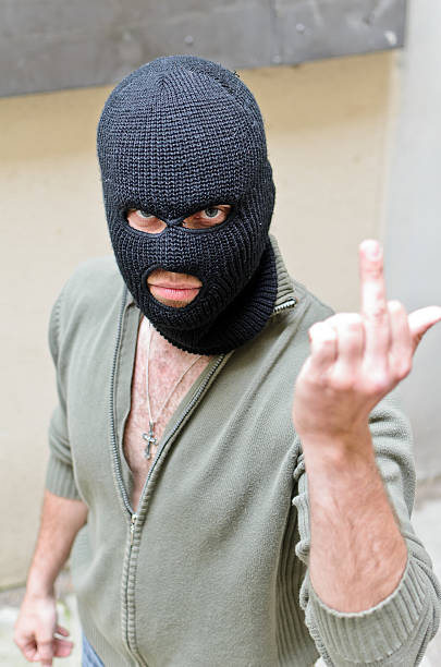 istock Burglar wearing a mask shows middle finger 177359951