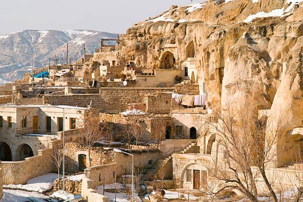 Close-up of cave dwellings of Uchisar castle in tufa cones at Nevsehir Province in Cappadocia, Turkey. House is carved into an sandstone rock formations.