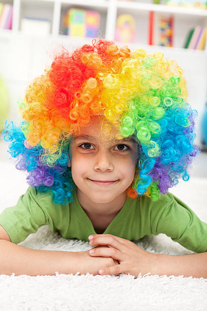istock Young boy with clown wig 177360208