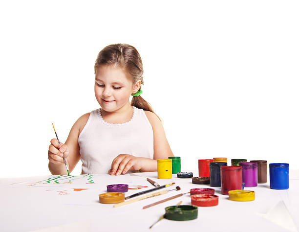 istock small beautiful girl paints on paper over white 177362579