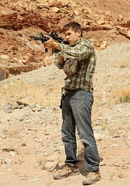 istock Teenage boy shooting at targets. 177362699
