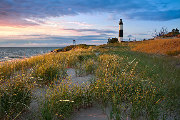 Big Sable Point Lighthouse. "Image of the Big Sable Point Lighthouse and the Lake Michigan shoreline, Michigan, USA." lake michigan photos stock pictures, royalty-free photos & images