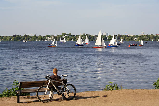 Man looks at yachts Man looks at yachts at Alster lake in Hamburg.Please see some more Hamburg pictures from my portfolio: aussenalster lake stock pictures, royalty-free photos & images