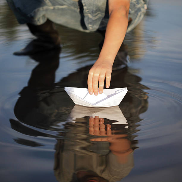 istock paper ship in children hand 177363970