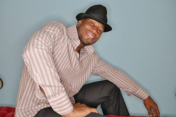 istock Seated man in a hat and striped short 177364460