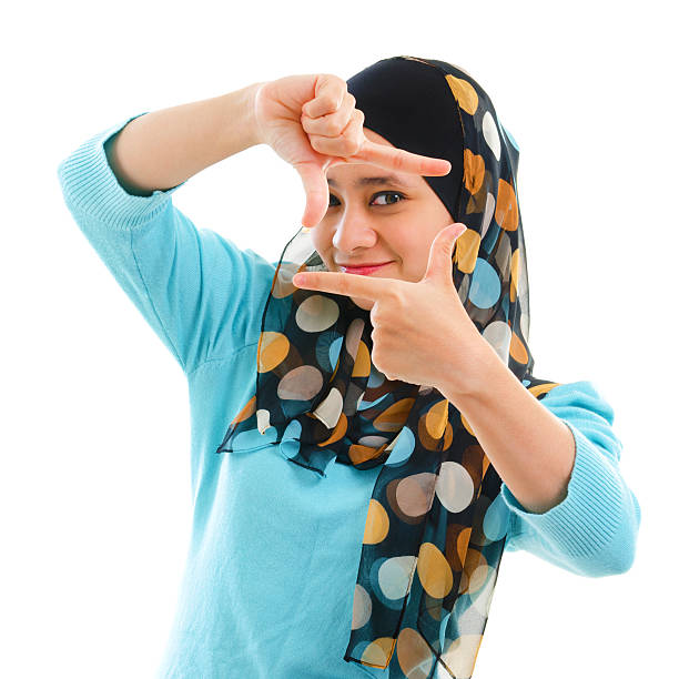 Smiling Asian Muslim woman making a frame with fingers Smiling Asian Muslim woman making a frame with fingers muslim photographer stock pictures, royalty-free photos & images