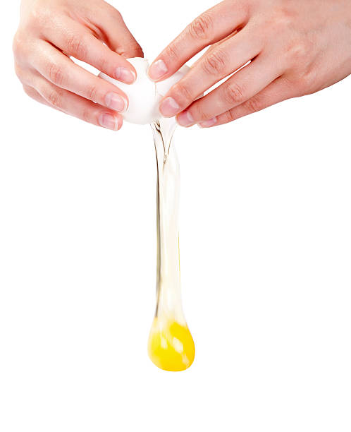 istock Close-up of hands cracking egg in midair isolated on white 177364971