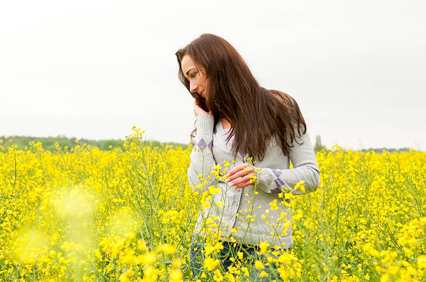 istock beautiful  woman in canola field 177365347