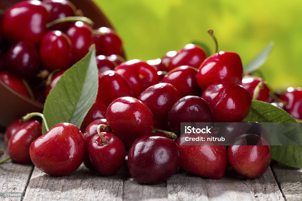 fresh cherries fresh cherries on wooden table Berry Fruit Stock Photo