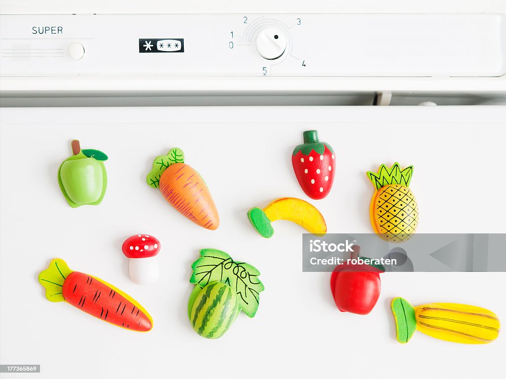 Refrigerator magnets shaped like fruit collection of magnets fridge in the form of fruit and vegetables placed on refrigerator door Magnet Stock Photo