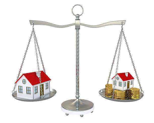 istock Large and small home with gold coins on the scale 177366265