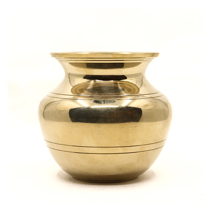 a clean golden indian brass vessel used as a water pot for traditional rituals during religious hindu festivals isolated in a white background