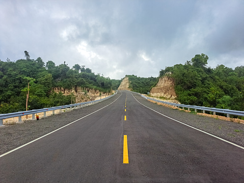 Asphalt Road. Landscape With A Perfect Asphalt In The Afternoon. High Rocks, Cloudy Sky. Panoramic. Travel Background