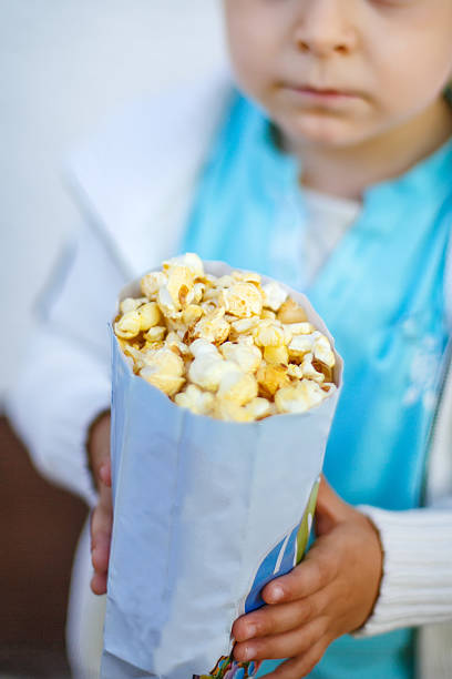 istock Happy little boy with popcorn bag 177369456