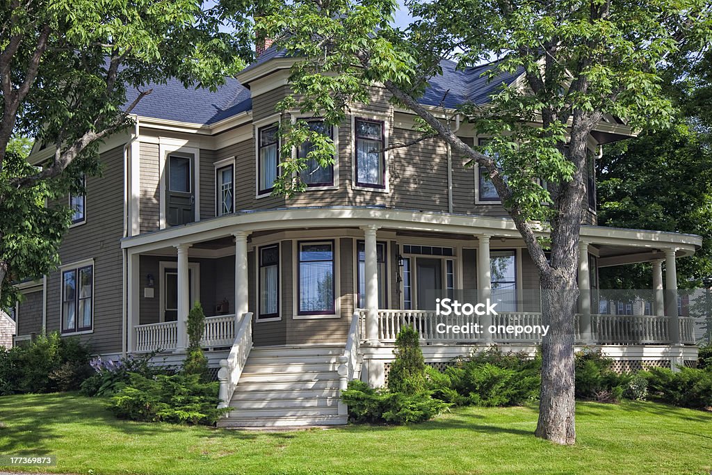 Older Home Classic older north American home surrounded by shady trees. Tree Stock Photo