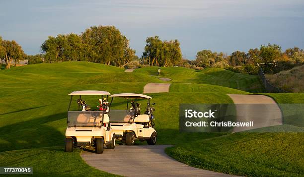 Pair Of Golf Carts On The Green Course At Sunset Stock Photo - Download Image Now - Country Club, Golf Course, Golf Cart