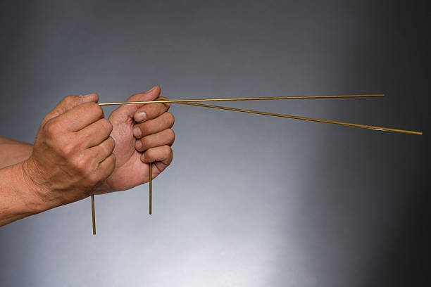 Man holding dowsing rods with both hands stock photo