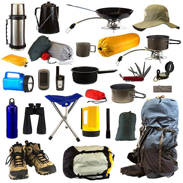 Camping Gear "Camping gear collage isolated on white background depicting a thermos, coffee pot, frying pan sitting on stove, hat, bags of camping equipment, stainless steel mug, pot sitting on stove, blue flashlight, GPS, walkie talkie, pot, Swiss army knife, compass, blue water bottle, black binoculars, chair, yellow flashlight, black flashlight, magnesium fire starter, backpack, hiking boots and sleeping bag." camping stove photos stock pictures, royalty-free photos & images