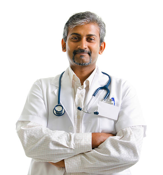 Indian male doctor Indian mature male doctor crossed arms on white background culture of india stock pictures, royalty-free photos & images