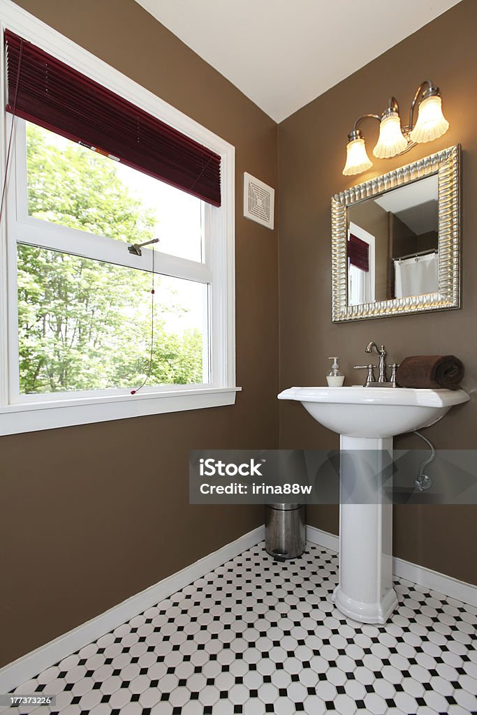 Brown small bathroom with antique sink and tiles. Classy Brown small bathroom with antique sink and tiles Apartment Stock Photo
