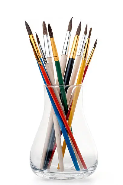 Group of paintbrushes in a glass jar