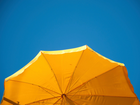 yellow sunshade an blue sky