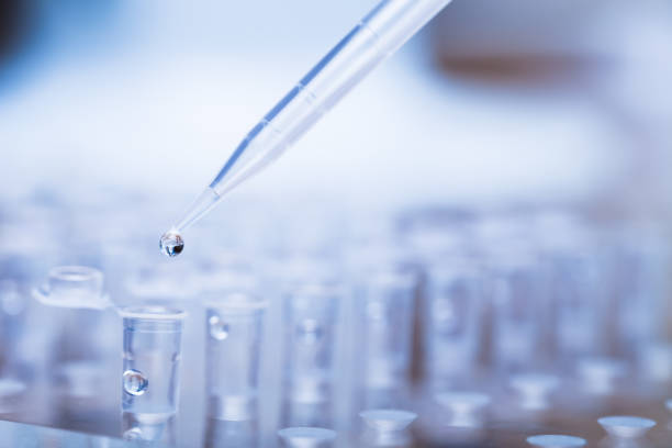 istock Pipette tip with droplet over rack of test tubes 177374858