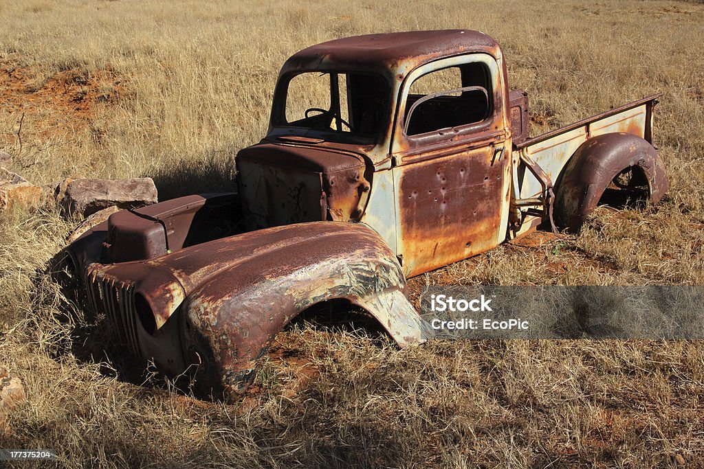 Rusty old pickup truck Wreck of a rusty old pickup truck out in the field. Abandoned Stock Photo