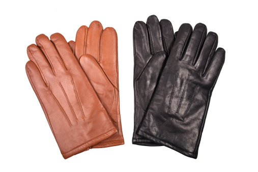 two pair of black and brown gloves isolated on white background