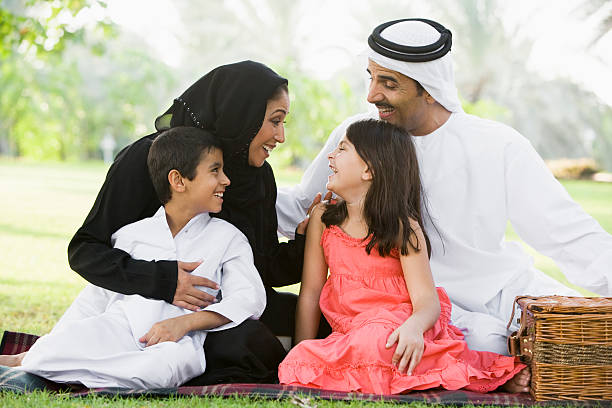 Middle Eastern family sitting in a park