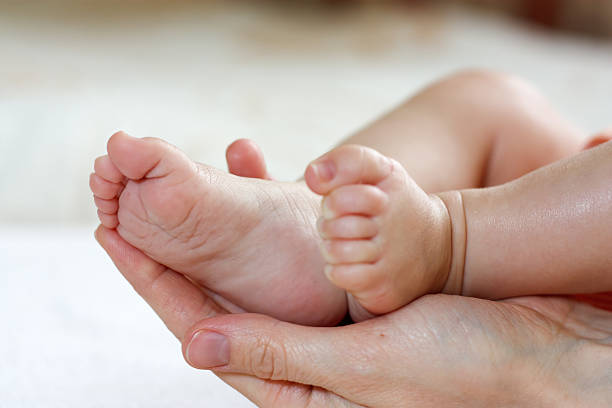 istock Baby feet in mother hands 177376423