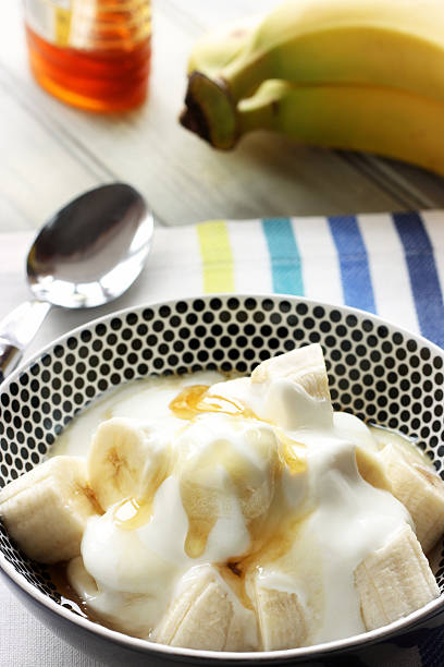 Banana with yoghurt and honey stock photo