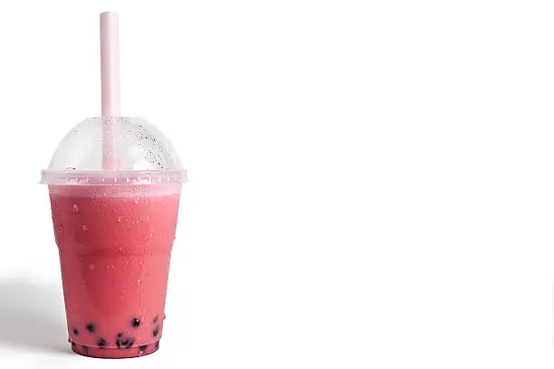Chilled pink strawberry bubble tea with tapioca bubbles.