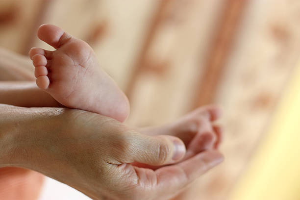 istock Baby feet in mother hands 177378613