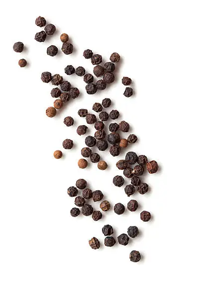 Black peppercorns isolated on white background.  Overhead view.