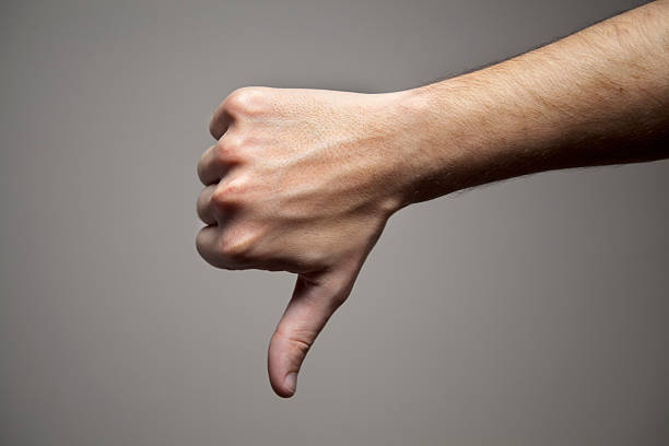 pessimistic man Male hand with its thumb down. pessimism photos stock pictures, royalty-free photos & images