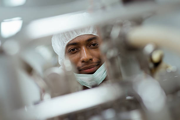 Male researcher checking equipment in biotech industry Lab technician working as researcher in biotechnology plant with machinery pharmaceutical factory stock pictures, royalty-free photos & images