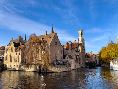 This image presents the magical atmosphere of Bruges during the Christmas period. The historic Belgian town, known for its fairy-tale medieval architecture, is draped in festive decorations. Streets and canals glisten with Christmas lights, and the air carries the scent of warm waffles and mulled wine from the holiday markets. Snow dusts the rooftops and cobblestones, adding to the city's timeless charm. The photograph aims to capture the essence of the holiday spirit that sweeps over Bruges, turning it into a Yuletide destination that offers a feast for the senses and a retreat into a bygone era of festive celebration.