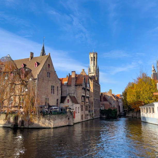This image presents the magical atmosphere of Bruges during the Christmas period. The historic Belgian town, known for its fairy-tale medieval architecture, is draped in festive decorations. Streets and canals glisten with Christmas lights, and the air carries the scent of warm waffles and mulled wine from the holiday markets. Snow dusts the rooftops and cobblestones, adding to the city's timeless charm. The photograph aims to capture the essence of the holiday spirit that sweeps over Bruges, turning it into a Yuletide destination that offers a feast for the senses and a retreat into a bygone era of festive celebration.