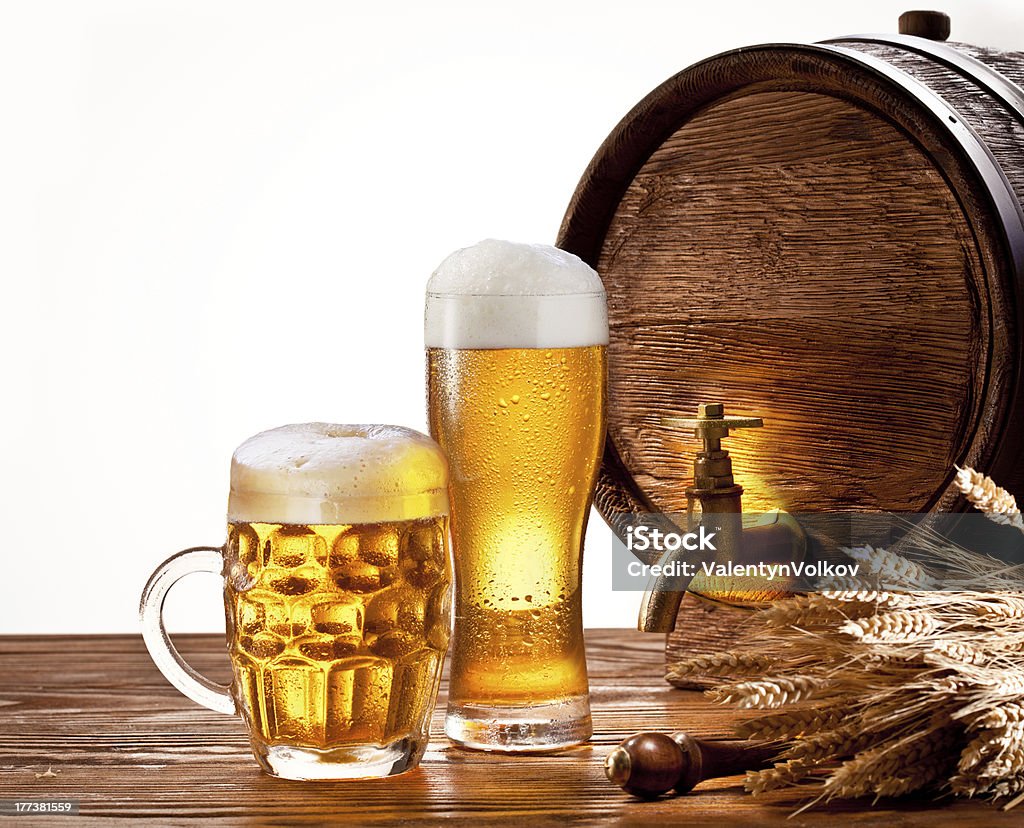 Beer barrel with glasses on a wooden table. Beer barrel with glasses on a wooden table. Isolated on a white background. Alcohol - Drink Stock Photo