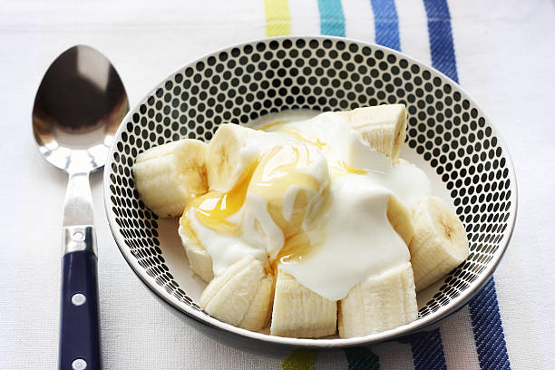 Banana with yoghurt and honey stock photo