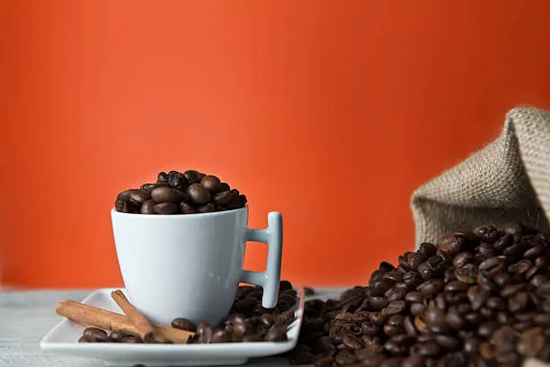 Photo of Cup ofcoffee full of beans.