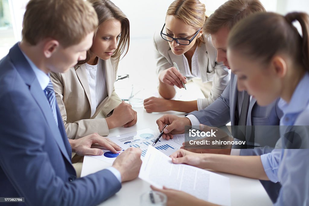 Working together Image of business partners discussing documents at meeting Adult Stock Photo