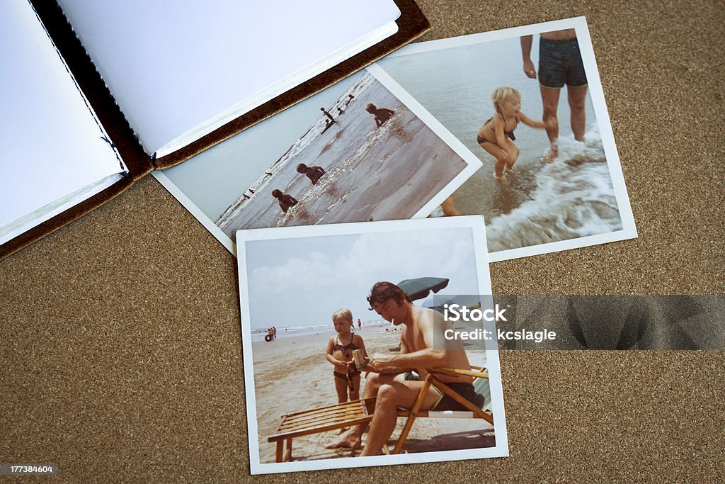 Bulletin board with 1970s family photos at beach Old photo album and photographs from the early 1970's of family at a beach on a bulletin board. Photograph Stock Photo
