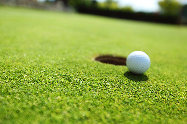 istock golf ball on lip of cup 177386145